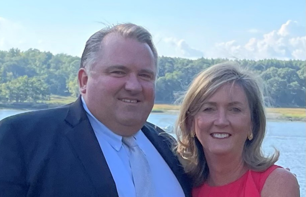 Peter and Marcie Coffin standing in front of a lake