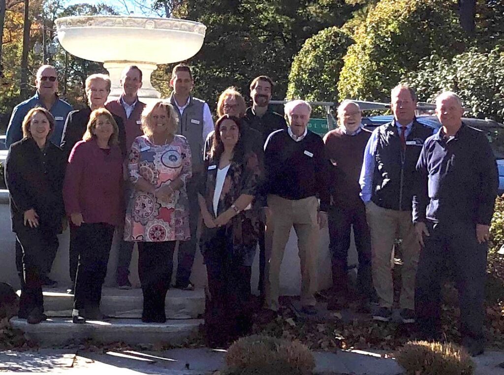 Photo of Ridgefield Library Board in front of a fountain