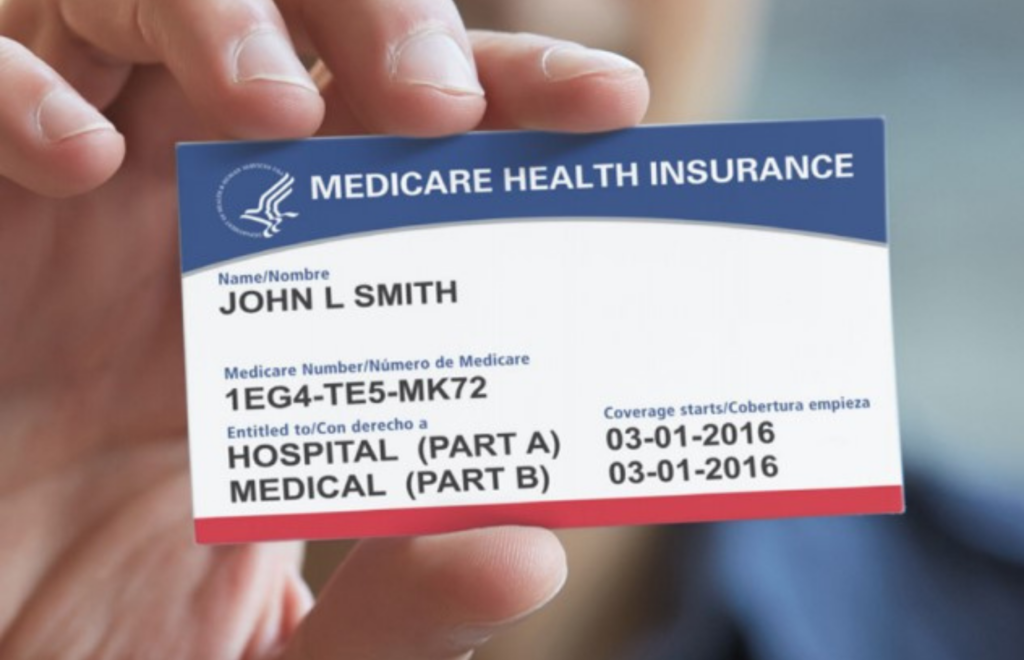 Hand holding Medicare card