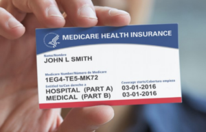 Hand holding Medicare card