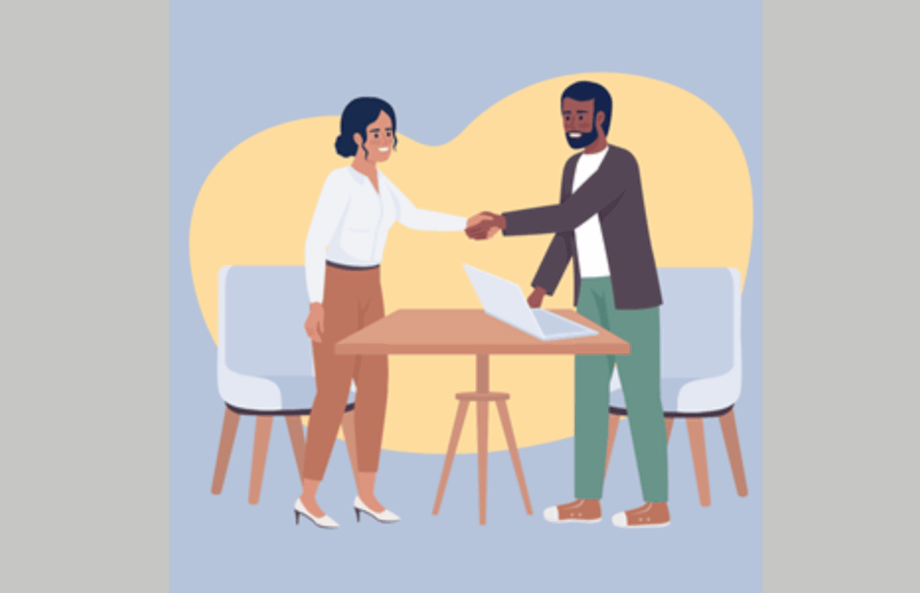 two people shaking hands over a table