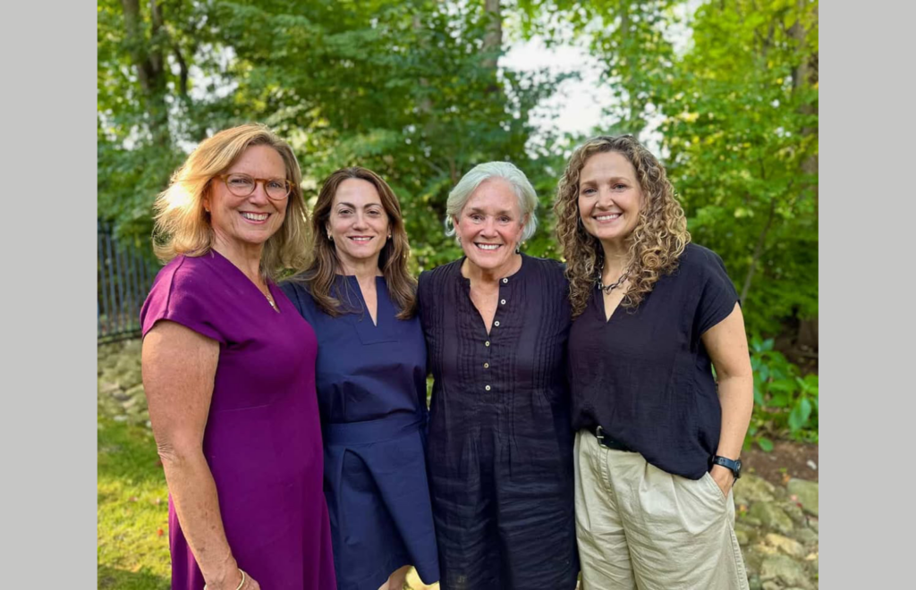 Four women in a backyard