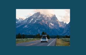 car driving toward mountain